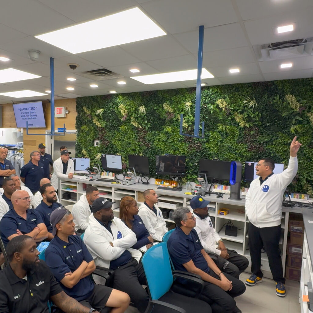 Sudsies team gathered for an internal training meeting inside the boutique operations area.