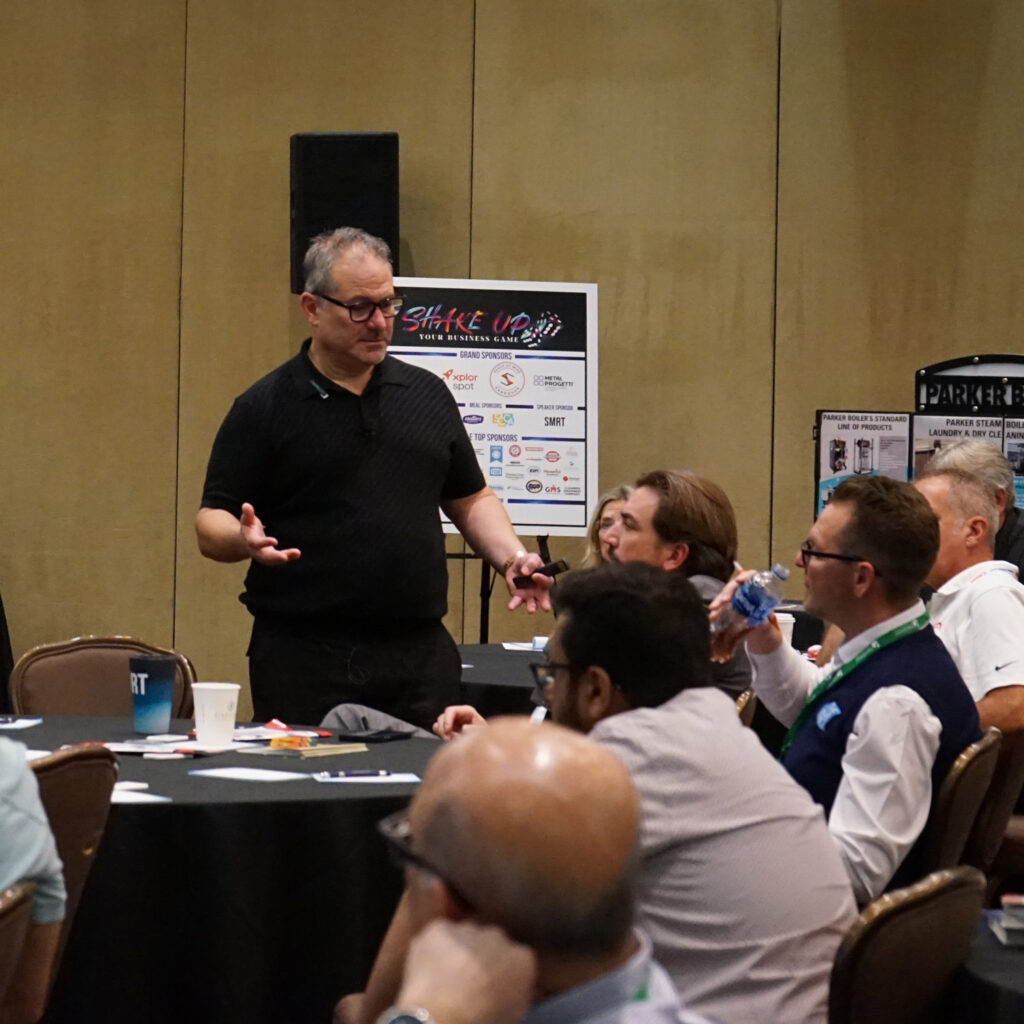 Industry leader presenting to professionals during garment care workshop