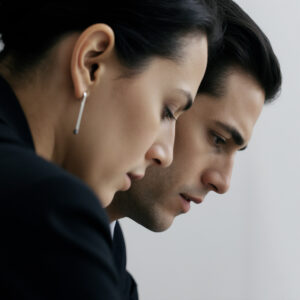 Two professionals closely collaborating during a focused business discussion about leadership and growth